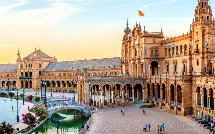 The brick towers, arcades and canal bridges of the Plaza de España in Seville